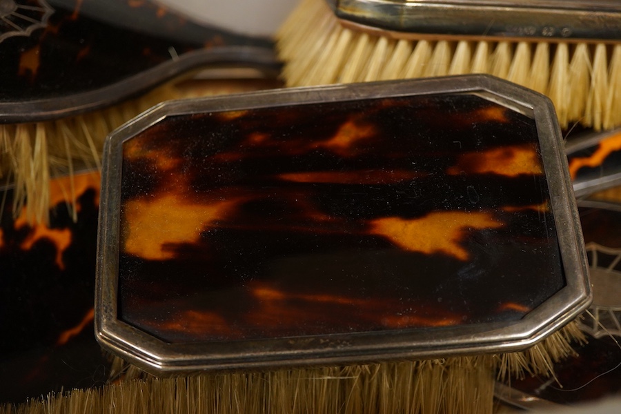 Two George V silver mounted tortoiseshell five piece dressing table sets, first Birmingham, 1925, Levi & Salaman, inlaid with fan paterae second in Art Deco style London, 1931, Collett & Anderson, (10)
